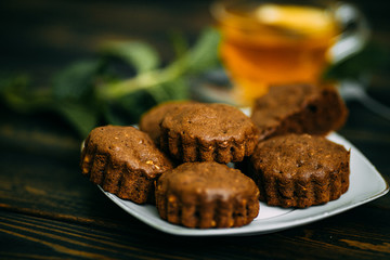 homemade cakes, chocolate muffins with mint and tea with lemon