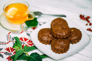 homemade cakes, chocolate muffins with mint and tea with lemon
