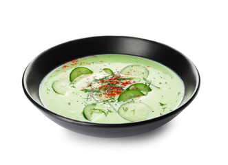 Bowl with cold cucumber soup on white background
