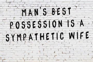 Painted black mindful inscription on white brick wall background