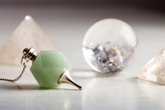crystal ball, rock crystal pyramid and Pendulum