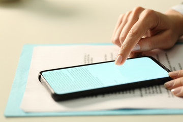 Executive hand signing contract on phone with finger