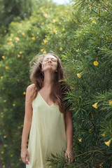 woman with closed eyes stay near greens - 347868705