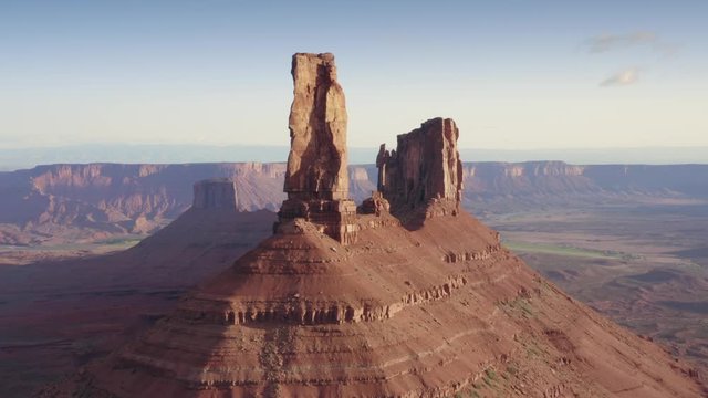 Aerial: Moab, Utah. Flying over desert and buttes in Castle Valley at sunrise. 