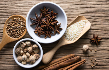 Variety of spices and natural herbs supplements health food on rustic table.