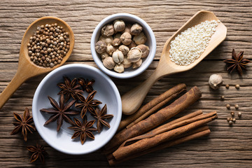 Variety of spices and natural herbs supplements health food on rustic table.