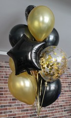 Set of helium balloons in gold and black colors. The concept of decorating a room with helium balloons for holidays or birthdays.