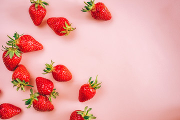 Fresh strawberry on the light pink background. View from above. Place for text.