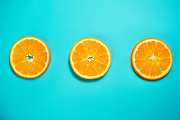 Fresh orange on the light turquoise background. View from above. Place for text.