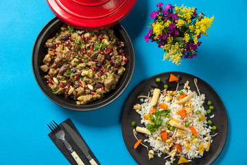 Traditional morroccon cuisine: Tagine/Tajine food. Dish made with lamb, chicken, pomegranate and almond served with carrot, corn, chick pea and potato garnished rice.