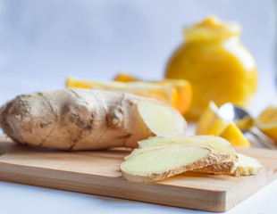 Jar of jam from orange, lemon with honey and ginger and slices of lemon and orange 