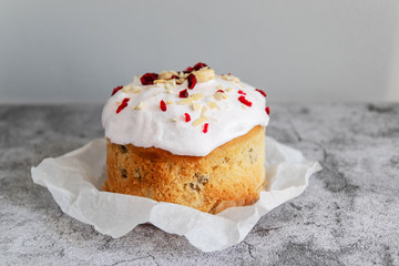 Glazed easter cake with cranberries and nuts on a gray background with copy space