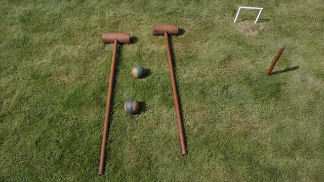 Croquet equipment is lying on the green lawn