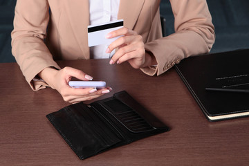 A woman makes purchases online. Purchases by Bank transfer. Unrecognizable photo. Only hand. The view from the top. Copy of the space.