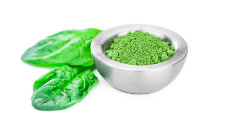 Spinach powder isolated on white (close up; selective focus)