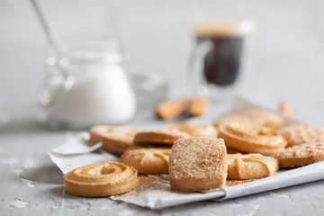 cookies with sugar and a cup of coffeee on ceramic background