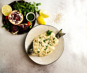 Lebanese fish with tahini sauce, pomegranate seeds and almonds  (SAMKE HARRA)