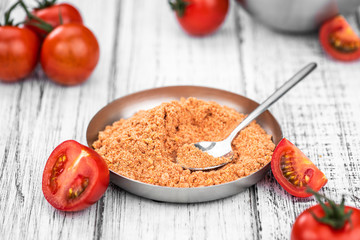 Tomato Powder (close up; selective focus) on vintage background