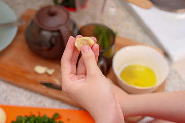 The girl peels and slices the garlic. Cooking at home.