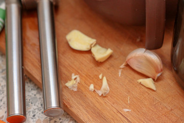 Cooking at home. Kitchen utensils and chopped garlic.