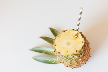 ripe pineapple fruit with a sliced top, cocktail roll, stylized green leaves, tropical bar concept