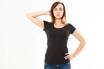 Advertising and T-shirt design concept. Cropped portrait of stylish woman wearing black T-shirt and blue jeans standing against white studio wall with copy space for your promotional content