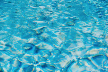 Fototapeta na wymiar Swimming pool water texture, bright aqua blue color abstract summer blurred background with copy space 
