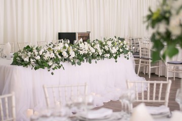 Main table at a wedding reception with beautiful flowers