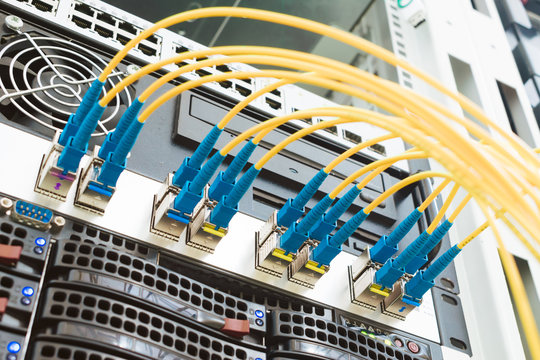 High-speed data transfer in a fiber-optic network. Communication equipment in the server room of the data center. Many fiber patch cords are connected to the interfaces of Central Internet router