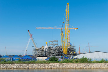Construction Industry oil rig refinery working site with blue sky background