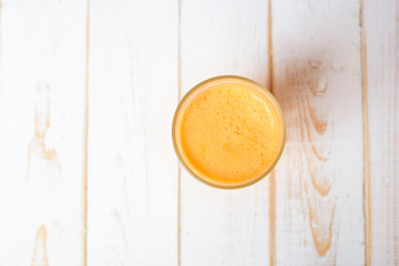 A glass of Orange juice on wood background