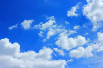 Naklejka na ściany i meble White clouds in the blue spring sky