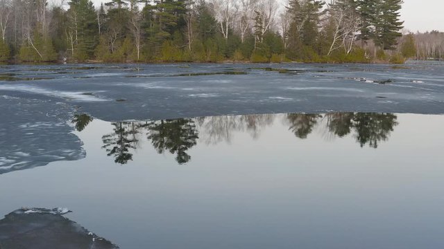 Hebron Lake in Monson Maine melting ice reflective water 