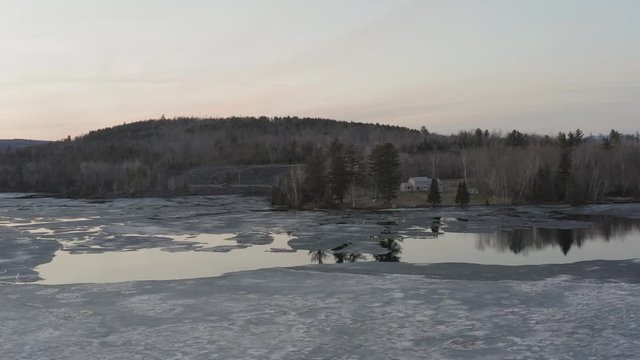 scenic view of melting ice over Hebron Lake, Monson Maine 