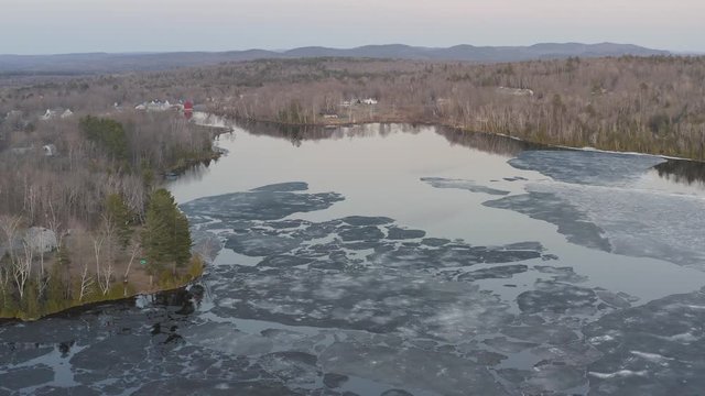 Hebron Lake, Monson Maine wide establishing aerial melting ice 