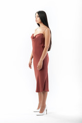 Fototapeta premium brunette posing in clothes for a catalog on a white background