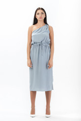 brunette posing in clothes for a catalog on a white background