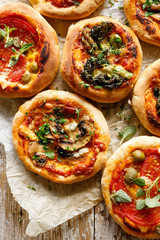 Vegetarian small pizzas with various toppings, top view