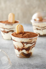Traditional Italian dessert tiramisu in a glass.