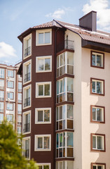 New-constructed multi-storey residential building. multi-storey residential house in brown and beige colors. Modern residential construction. Residential fund