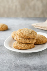 Chocolate chip cookies on linen napkin on gray table. Stacked chocolate chip cookies close up.