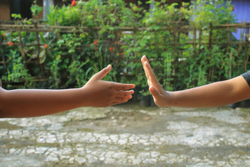 Two hands that want to touch each other. Social reminder.