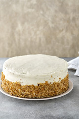 carrot cake with walnuts, prunes and dried apricots on a gray background.
