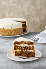 carrot cake with walnuts, prunes and dried apricots on a gray background.