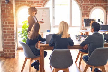 Obraz premium Group of business workers working together in a meeting. One of them making presentation to colleagues at the office