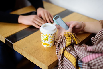 Two women discussing in a cafe while having coffee.