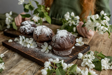 Delicious chocolate cupcakes on a wooden table