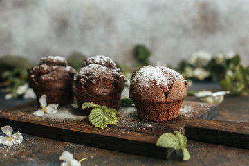 Delicious chocolate cupcakes on a wooden table