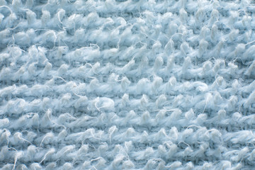Macro photo of light blue towel texture background.