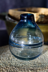 Blue round glass vase on the straw napkin